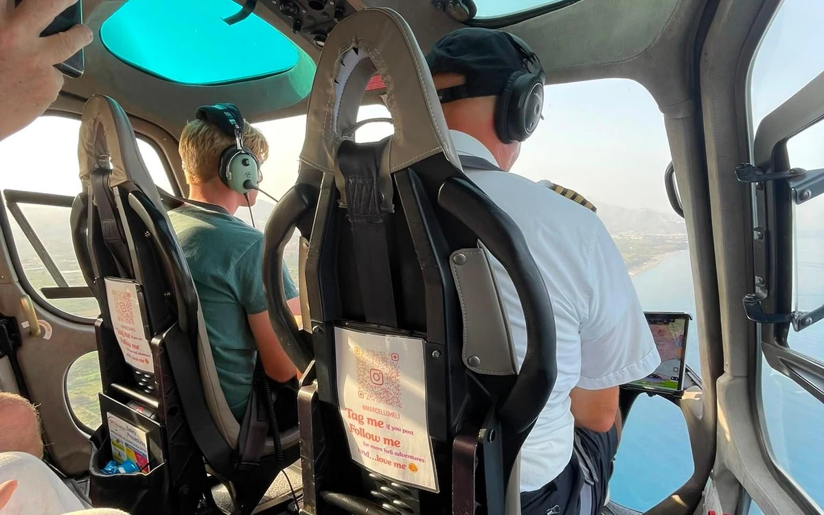 A helicopter on the pad at the Ionian coast before a flight over the volcano